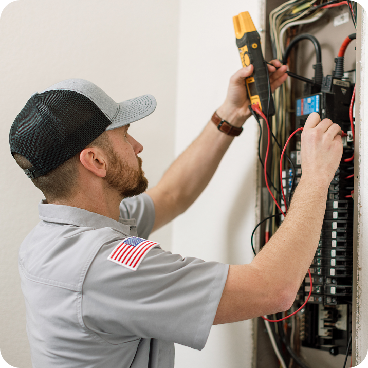 Aegis Electric technician working on an electrical panel